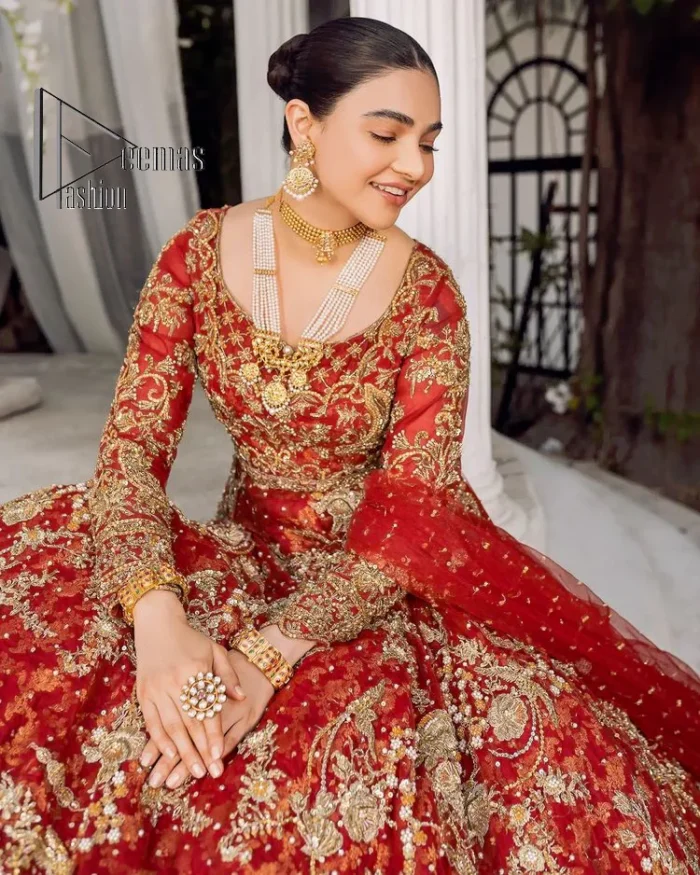 Feels just redish on your Big day to make your day lovely and romantic. DeemasFashion presents this Pakistani reception wear for you in bright red colour which begins with a flared back train maxi. The maxi is attractively and laboriously adorned with golden embroidery that enhances tilla,dabka, kora and Kundan. In addition to this, the boat shape neckline intensifies the beauty of this Pakistani reception wear when comes with full sleeves. The flared back train of the maxi is also heavily embellished. Complete this article with a dupatta in the same colour which is adorned with four-sided borders and tiny floral motifs, sequins spray all over to make you fresh on your Big day.