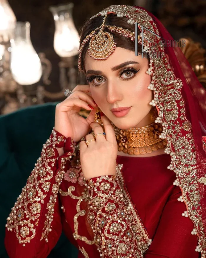 There is a shade of deep red for every bride. This Pakistani reception article begins with a deep red blouse which is simple but handsome and attractive. The blouse has boat shape neckline and full sleeves. The border of the sleeves is beautifully embellished with light golden embroidery. Furthermore, the Pakistani reception article also includes a fit and flare lehenga having heavy embroidery in light golden colour to make your day more romantic. Complete this Pakistani reception article with a deep red dupatta which is adorned with a four-sided border to give you a flavour shade of a Pakistani bride.