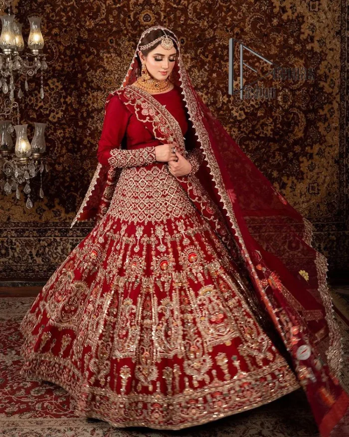 There is a shade of deep red for every bride. This Pakistani reception article begins with a deep red blouse which is simple but handsome and attractive. The blouse has boat shape neckline and full sleeves. The border of the sleeves is beautifully embellished with light golden embroidery. Furthermore, the Pakistani reception article also includes a fit and flare lehenga having heavy embroidery in light golden colour to make your day more romantic. Complete this Pakistani reception article with a deep red dupatta which is adorned with a four-sided border to give you a flavour shade of a Pakistani bride.