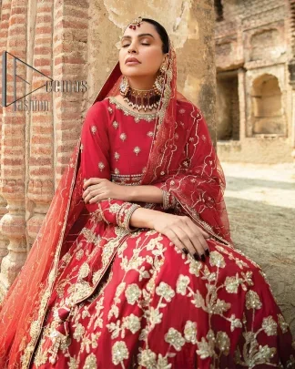 Begin your new life by wearing a romantic deep red outfit. Introducing this Pakistani reception wear that begins with a handsome blouse which is adorned with tiny floral motifs all over in light golden colour. The boat shape neckline steals the spotlight of the event when comes with three-quarter sleeves. It is combined with flared lehenga which is heavily adorned with a light golden embroidery to make your event lovely and charming. Complete this Pakistani reception wear with a dupatta in the same colour which border is heavily embellished that is ideal for modern festives.