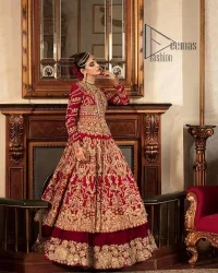 Happiness and confidence are the prettiest things that are associated with your wedding outfit. DeemasFashion presents this Pakistani reception wear in deep red colour. The deep red heavy maxi of this Pakistani reception wear is gorgeously adorned with a golden embroidery which is further enhanced with tilla, dabka, and kora. The boat shape neckline speaks of the boldness of the outfit. The following maxi is paired up with maroon sharara whose border is also embellished. Out and out of this Pakistani reception wears a dupatta in the same colour which is adorned with a four-sided border. Further, it is decorated with sequins sprayed all over.
