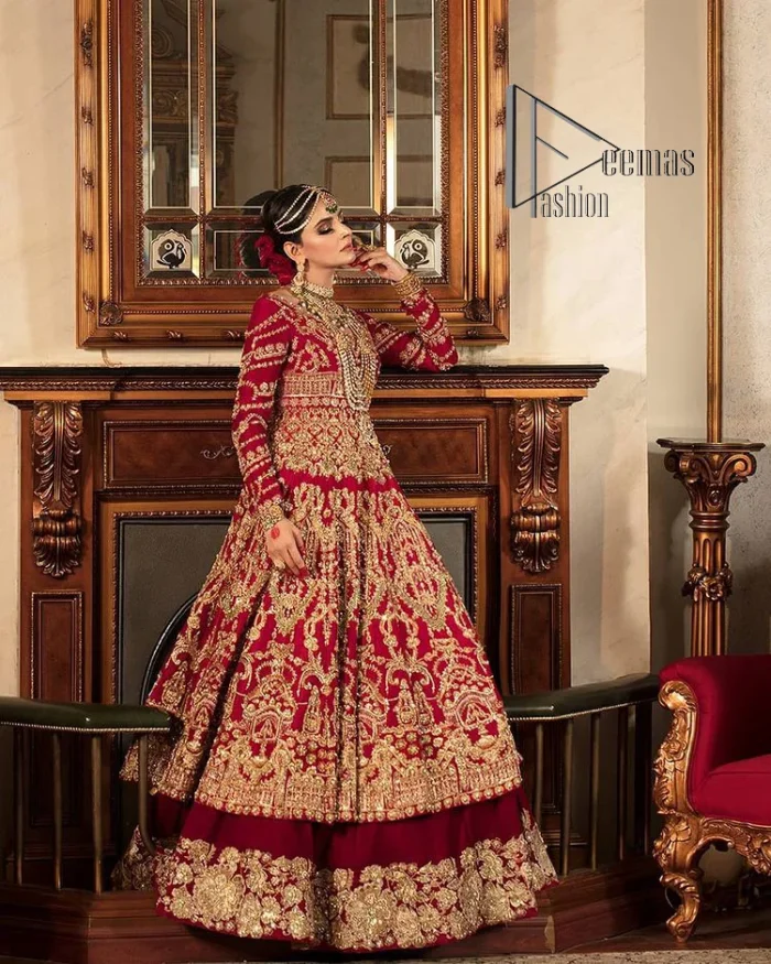 Happiness and confidence are the prettiest things that are associated with your wedding outfit. DeemasFashion presents this Pakistani reception wear in deep red colour. The deep red heavy maxi of this Pakistani reception wear is gorgeously adorned with a golden embroidery which is further enhanced with tilla, dabka, and kora. The boat shape neckline speaks of the boldness of the outfit. The following maxi is paired up with maroon sharara whose border is also embellished. Out and out of this Pakistani reception wears a dupatta in the same colour which is adorned with a four-sided border. Further, it is decorated with sequins sprayed all over.