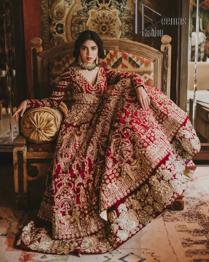 Deep red on Big day is just associated with love and romance. The deep red panelled frock is beautifully decorated with heavy light golden embroidery which includes tilla, dabka, kora and Kundan. In addition to this, the V shape neckline looks super romantic when comes with full sleeves. It is paired up with a heavy flared lehenga which is again adorned with lovely embroidery. Out and out this Pakistani reception article with dupatta having a four-sided embellished border to make your day super charming.
