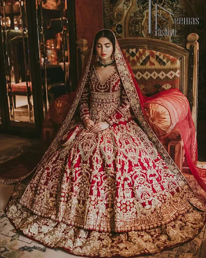 Deep red on Big day is just associated with love and romance. The deep red panelled frock is beautifully decorated with heavy light golden embroidery which includes tilla, dabka, kora and Kundan. In addition to this, the V shape neckline looks super romantic when comes with full sleeves. It is paired up with a heavy flared lehenga which is again adorned with lovely embroidery. Out and out this Pakistani reception article with dupatta having a four-sided embellished border to make your day super charming.