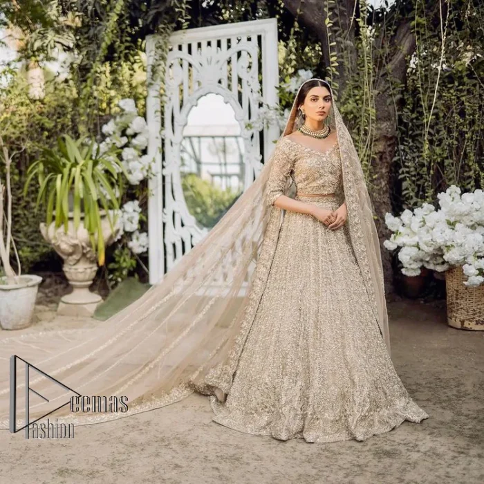 If you are getting married, you need a quality outfit. So, DeemasFashion presents this nikah outfit for you in fawn colour which begins with a fawn blouse that is laboriously and meticulously hand–rendered with silver and matching embroidery. It enhances with tilla, dabka, kora and Kundan that is portraying the dreamy vibe. The V Shape neckline of the blouse is a stylish way to steal the spotlight. The Nikah outfit is paired up with a can-can lehenga which is again heavily embellished with lushly detailed embroidery. Complete this nikah outfit with a dupatta in the same colour which is beautifully ornamented with a four-sided border which is ideal for modern festives.