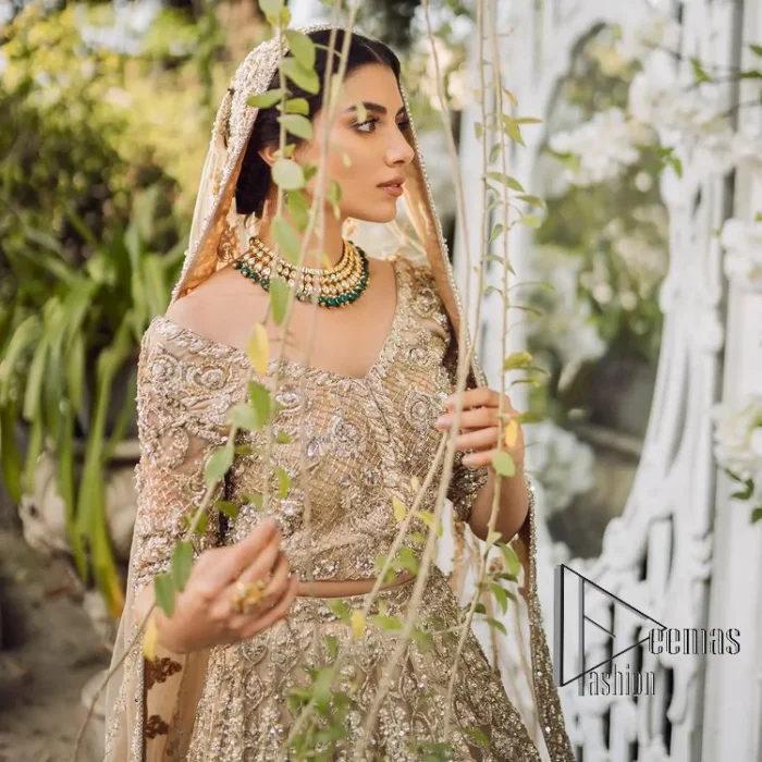 If you are getting married, you need a quality outfit. So, DeemasFashion presents this nikah outfit for you in fawn colour which begins with a fawn blouse that is laboriously and meticulously hand–rendered with silver and matching embroidery. It enhances with tilla, dabka, kora and Kundan that is portraying the dreamy vibe. The V Shape neckline of the blouse is a stylish way to steal the spotlight. The Nikah outfit is paired up with a can-can lehenga which is again heavily embellished with lushly detailed embroidery. Complete this nikah outfit with a dupatta in the same colour which is beautifully ornamented with a four-sided border which is ideal for modern festives.