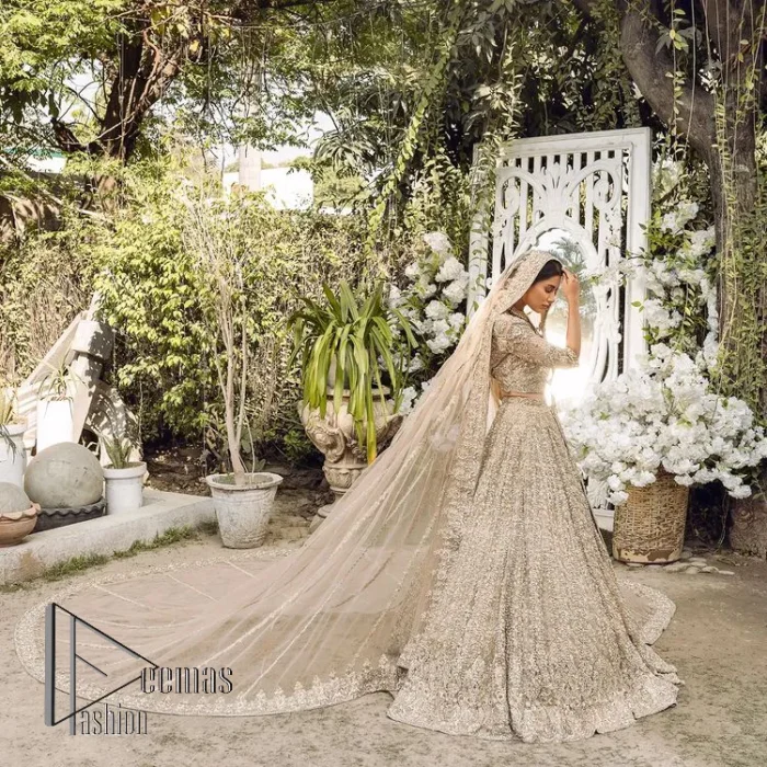 If you are getting married, you need a quality outfit. So, DeemasFashion presents this nikah outfit for you in fawn colour which begins with a fawn blouse that is laboriously and meticulously hand–rendered with silver and matching embroidery. It enhances with tilla, dabka, kora and Kundan that is portraying the dreamy vibe. The V Shape neckline of the blouse is a stylish way to steal the spotlight. The Nikah outfit is paired up with a can-can lehenga which is again heavily embellished with lushly detailed embroidery. Complete this nikah outfit with a dupatta in the same colour which is beautifully ornamented with a four-sided border which is ideal for modern festives.