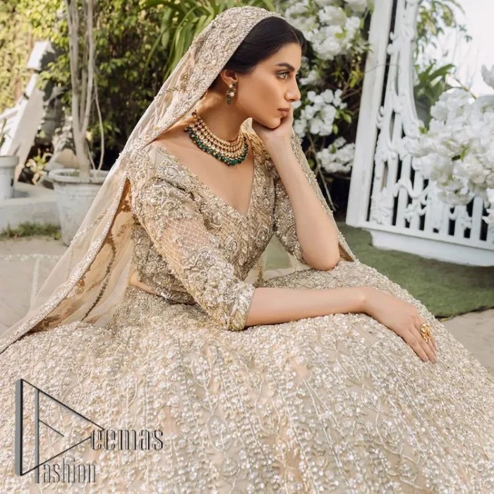 If you are getting married, you need a quality outfit. So, DeemasFashion presents this nikah outfit for you in fawn colour which begins with a fawn blouse that is laboriously and meticulously hand–rendered with silver and matching embroidery. It enhances with tilla, dabka, kora and Kundan that is portraying the dreamy vibe. The V Shape neckline of the blouse is a stylish way to steal the spotlight. The Nikah outfit is paired up with a can-can lehenga which is again heavily embellished with lushly detailed embroidery. Complete this nikah outfit with a dupatta in the same colour which is beautifully ornamented with a four-sided border which is ideal for modern festives.