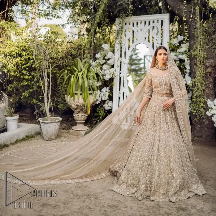 If you are getting married, you need a quality outfit. So, DeemasFashion presents this nikah outfit for you in fawn colour which begins with a fawn blouse that is laboriously and meticulously hand–rendered with silver and matching embroidery. It enhances with tilla, dabka, kora and Kundan that is portraying the dreamy vibe. The V Shape neckline of the blouse is a stylish way to steal the spotlight. The Nikah outfit is paired up with a can-can lehenga which is again heavily embellished with lushly detailed embroidery. Complete this nikah outfit with a dupatta in the same colour which is beautifully ornamented with a four-sided border which is ideal for modern festives.