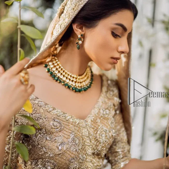 If you are getting married, you need a quality outfit. So, DeemasFashion presents this nikah outfit for you in fawn colour which begins with a fawn blouse that is laboriously and meticulously hand–rendered with silver and matching embroidery. It enhances with tilla, dabka, kora and Kundan that is portraying the dreamy vibe. The V Shape neckline of the blouse is a stylish way to steal the spotlight. The Nikah outfit is paired up with a can-can lehenga which is again heavily embellished with lushly detailed embroidery. Complete this nikah outfit with a dupatta in the same colour which is beautifully ornamented with a four-sided border which is ideal for modern festives.