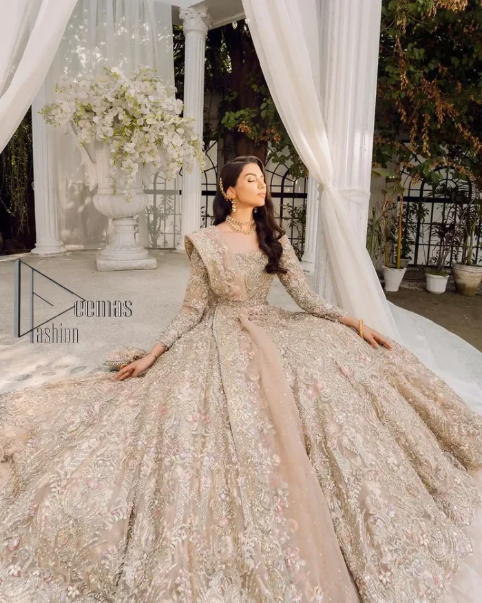 Begin your new life by wearing a dreamy nikah outfit of deemasFashion. Introduce this nikkah outfit with a light fawn frilled heavy maxi that is laboriously hand-rendered with silver and the same colour embroidery that enhances tilla, dabka, kora and crystal. The boat shape neckline and full sleeves of this maxi also add memorable beauty to your amazing Qabool Hai moment. The maxi of this nikah wear is systemized with a dupatta in the same colour which is ornamented with four-sided borders and sequins sprayed all over to enhance the attractiveness of the nikah outfit.