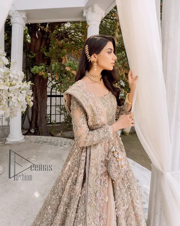 Begin your new life by wearing a dreamy nikah outfit of deemasFashion. Introduce this nikkah outfit with a light fawn frilled heavy maxi that is laboriously hand-rendered with silver and the same colour embroidery that enhances tilla, dabka, kora and crystal. The boat shape neckline and full sleeves of this maxi also add memorable beauty to your amazing Qabool Hai moment. The maxi of this nikah wear is systemized with a dupatta in the same colour which is ornamented with four-sided borders and sequins sprayed all over to enhance the attractiveness of the nikah outfit.