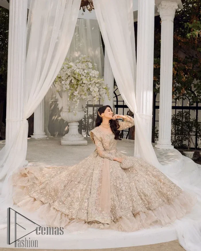 Begin your new life by wearing a dreamy nikah outfit of deemasFashion. Introduce this nikkah outfit with a light fawn frilled heavy maxi that is laboriously hand-rendered with silver and the same colour embroidery that enhances tilla, dabka, kora and crystal. The boat shape neckline and full sleeves of this maxi also add memorable beauty to your amazing Qabool Hai moment. The maxi of this nikah wear is systemized with a dupatta in the same colour which is ornamented with four-sided borders and sequins sprayed all over to enhance the attractiveness of the nikah outfit.