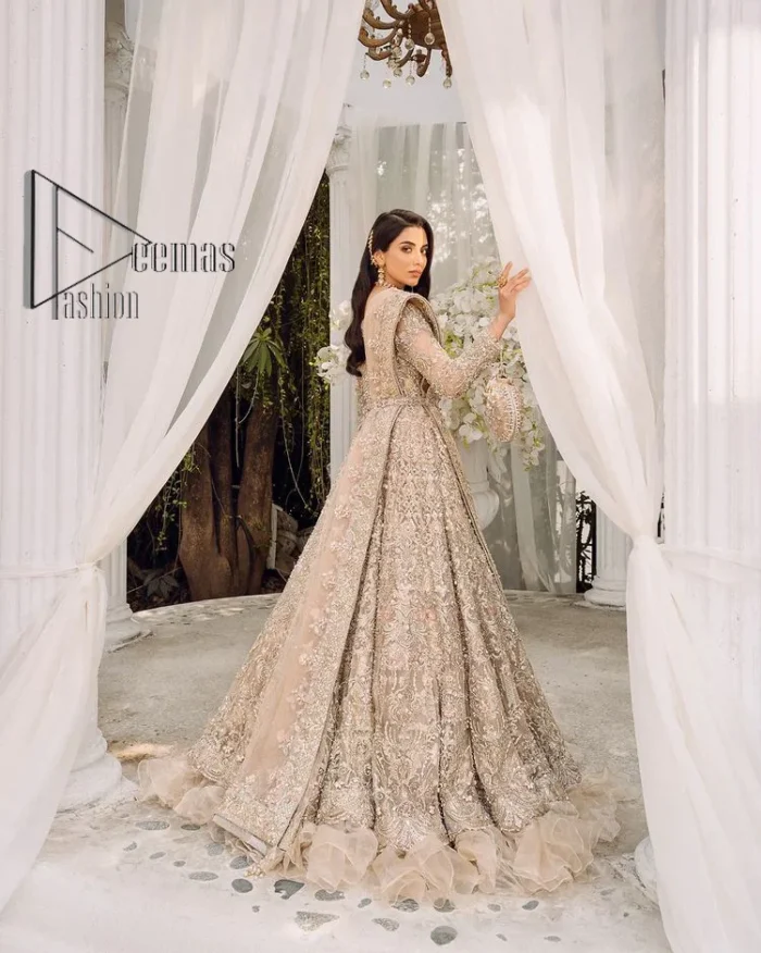 Begin your new life by wearing a dreamy nikah outfit of deemasFashion. Introduce this nikkah outfit with a light fawn frilled heavy maxi that is laboriously hand-rendered with silver and the same colour embroidery that enhances tilla, dabka, kora and crystal. The boat shape neckline and full sleeves of this maxi also add memorable beauty to your amazing Qabool Hai moment. The maxi of this nikah wear is systemized with a dupatta in the same colour which is ornamented with four-sided borders and sequins sprayed all over to enhance the attractiveness of the nikah outfit.