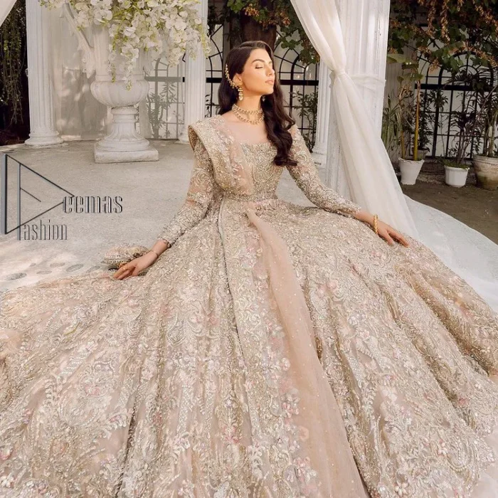 Begin your new life by wearing a dreamy nikah outfit of deemasFashion. Introduce this nikkah outfit with a light fawn frilled heavy maxi that is laboriously hand-rendered with silver and the same colour embroidery that enhances tilla, dabka, kora and crystal. The boat shape neckline and full sleeves of this maxi also add memorable beauty to your amazing Qabool Hai moment. The maxi of this nikah wear is systemized with a dupatta in the same colour which is ornamented with four-sided borders and sequins sprayed all over to enhance the attractiveness of the nikah outfit.
