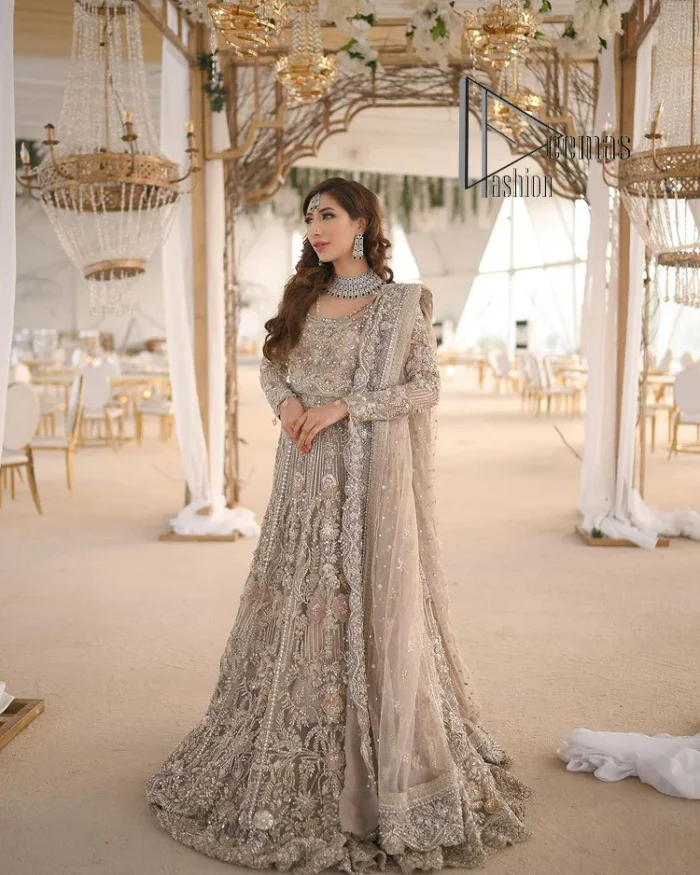 Start your new life by wearing DeemasFashion. Make your moment more memorable with light fawn heavy maxi nikah wear which is laboriously hand-rendered with silver and the same colour embroidery that enhances tilla, dabka, kora and crystal. The boat shape neckline and full sleeves of this maxi also add memorable beauty to your Qabool Hai moment. The maxi of this nikah wear is systemized with a dupatta in the same colour which is ornamented with four-sided borders and sequins sprayed all over to enhance the attractiveness of the nikah wear.