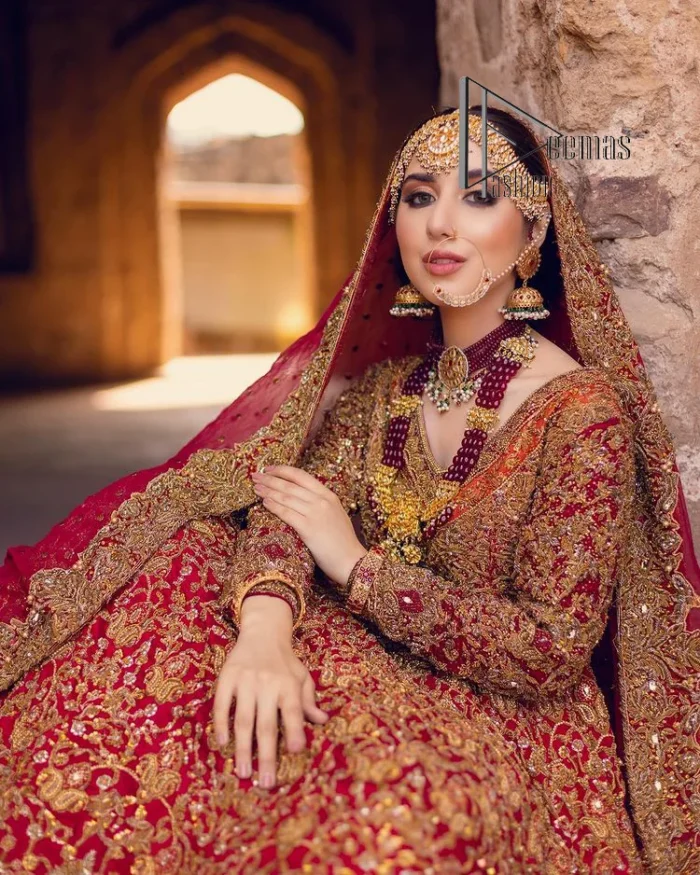 Happy is the bride the maroon shines on. Initiate this Pakistani reception outfit with a maroon heavy Anarkali which is sumptuously hand-rendered with golden embroidery that includes tilla, dabka, kora and Kundan. The V shape neckline of this Pakistani reception outfit exquisitely comes with full sleeves. It is paired up with rust farshi lehenga whose border is again adorned with golden embroidery. Finish this Pakistani reception outfit with a dupatta with a four-sided embellished border and sequins sprayed all over to put a maroonish shine on your big day.