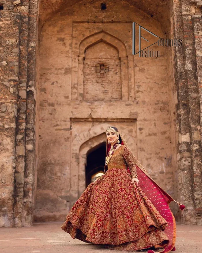 Happy is the bride the maroon shines on. Initiate this Pakistani reception outfit with a maroon heavy Anarkali which is sumptuously hand-rendered with golden embroidery that includes tilla, dabka, kora and Kundan. The V shape neckline of this Pakistani reception outfit exquisitely comes with full sleeves. It is paired up with rust farshi lehenga whose border is again adorned with golden embroidery. Finish this Pakistani reception outfit with a dupatta with a four-sided embellished border and sequins sprayed all over to put a maroonish shine on your big day.