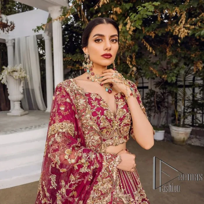 Make your day more lovely by wearing maroon colours. Maroon is just the star among all colours for the bride's Big day. So, DeemasFashion presents this maroon Pakistani reception outfit which begins with a traditional blouse that is meticulously adorned with light golden embroidery. Further, it is enhanced with tilla, dabka, kora and zardozi to make your day more remarkable. The three-quarter sleeves of the blouse add more beauty to this outfit. This Pakistani reception outfit is paired up with a can-can lehenga which is again heavily ornamented with light golden embroidery. Finish this article with a dupatta that is embellished with a four-sided border to fulfil your artistic look.