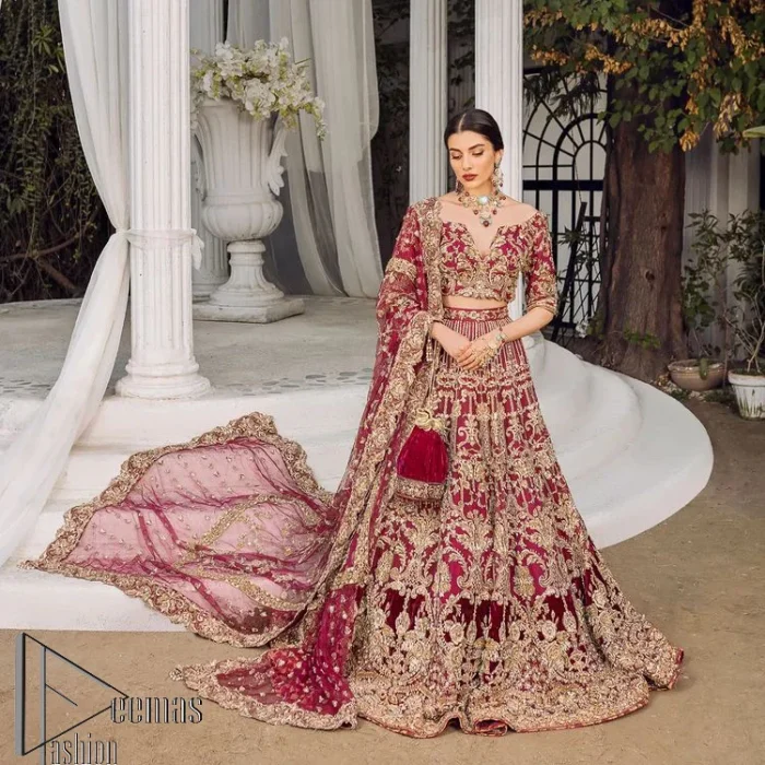 Make your day more lovely by wearing maroon colours. Maroon is just the star among all colours for the bride's Big day. So, DeemasFashion presents this maroon Pakistani reception outfit which begins with a traditional blouse that is meticulously adorned with light golden embroidery. Further, it is enhanced with tilla, dabka, kora and zardozi to make your day more remarkable. The three-quarter sleeves of the blouse add more beauty to this outfit. This Pakistani reception outfit is paired up with a can-can lehenga which is again heavily ornamented with light golden embroidery. Finish this article with a dupatta that is embellished with a four-sided border to fulfil your artistic look.
