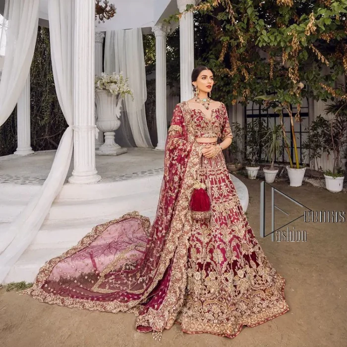 Make your day more lovely by wearing maroon colours. Maroon is just the star among all colours for the bride's Big day. So, DeemasFashion presents this maroon Pakistani reception outfit which begins with a traditional blouse that is meticulously adorned with light golden embroidery. Further, it is enhanced with tilla, dabka, kora and zardozi to make your day more remarkable. The three-quarter sleeves of the blouse add more beauty to this outfit. This Pakistani reception outfit is paired up with a can-can lehenga which is again heavily ornamented with light golden embroidery. Finish this article with a dupatta that is embellished with a four-sided border to fulfil your artistic look.