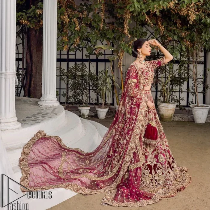 Make your day more lovely by wearing maroon colours. Maroon is just the star among all colours for the bride's Big day. So, DeemasFashion presents this maroon Pakistani reception outfit which begins with a traditional blouse that is meticulously adorned with light golden embroidery. Further, it is enhanced with tilla, dabka, kora and zardozi to make your day more remarkable. The three-quarter sleeves of the blouse add more beauty to this outfit. This Pakistani reception outfit is paired up with a can-can lehenga which is again heavily ornamented with light golden embroidery. Finish this article with a dupatta that is embellished with a four-sided border to fulfil your artistic look.