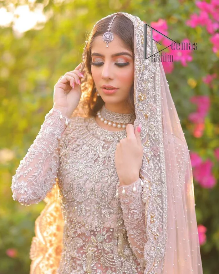 Introducing the mauve nikah outfit which begins with a short shirt that is meticulously and laboriously hand-rendered with silver embroidery which is embellished with tilla, dabka, and Sitara. Furthermore, the full sleeves of this nikah outfit are more attractive when come with a round-shaped neckline. It is coordinated with a fish-style heavy lehenga which is again ornamented with silver embroidery. Complete this nikah wear with a scalloped dupatta which is embellished with four-sided borders and sequins sprayed all over.
