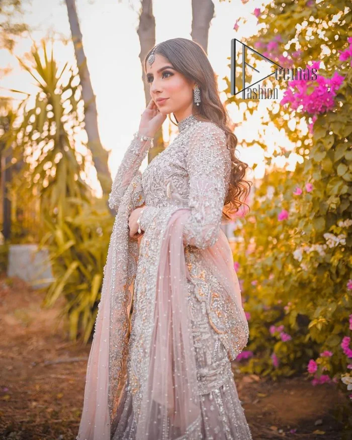 Introducing the mauve nikah outfit which begins with a short shirt that is meticulously and laboriously hand-rendered with silver embroidery which is embellished with tilla, dabka, and Sitara. Furthermore, the full sleeves of this nikah outfit are more attractive when come with a round-shaped neckline. It is coordinated with a fish-style heavy lehenga which is again ornamented with silver embroidery. Complete this nikah wear with a scalloped dupatta which is embellished with four-sided borders and sequins sprayed all over.