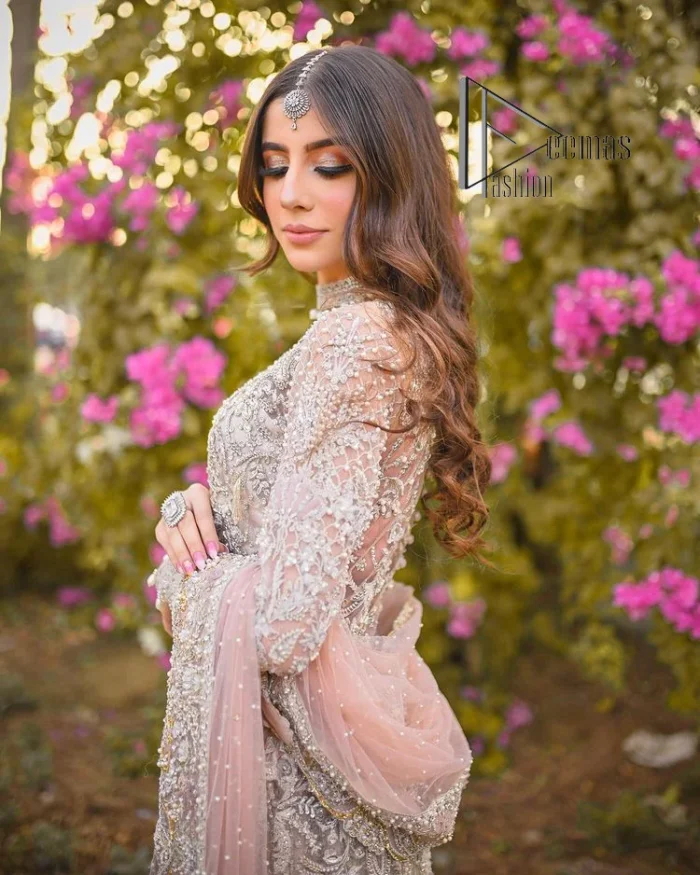Introducing the mauve nikah outfit which begins with a short shirt that is meticulously and laboriously hand-rendered with silver embroidery which is embellished with tilla, dabka, and Sitara. Furthermore, the full sleeves of this nikah outfit are more attractive when come with a round-shaped neckline. It is coordinated with a fish-style heavy lehenga which is again ornamented with silver embroidery. Complete this nikah wear with a scalloped dupatta which is embellished with four-sided borders and sequins sprayed all over.