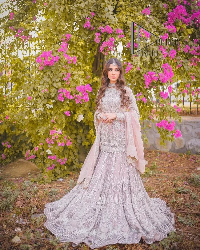 Introducing the mauve nikah outfit which begins with a short shirt that is meticulously and laboriously hand-rendered with silver embroidery which is embellished with tilla, dabka, and Sitara. Furthermore, the full sleeves of this nikah outfit are more attractive when come with a round-shaped neckline. It is coordinated with a fish-style heavy lehenga which is again ornamented with silver embroidery. Complete this nikah wear with a scalloped dupatta which is embellished with four-sided borders and sequins sprayed all over.