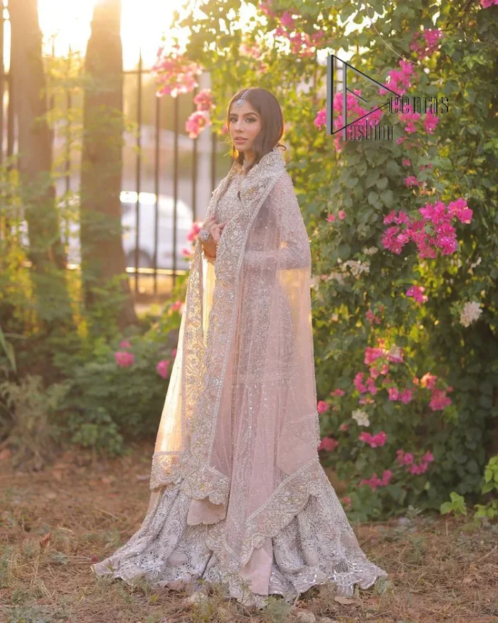 Introducing the mauve nikah outfit which begins with a short shirt that is meticulously and laboriously hand-rendered with silver embroidery which is embellished with tilla, dabka, and Sitara. Furthermore, the full sleeves of this nikah outfit are more attractive when come with a round-shaped neckline. It is coordinated with a fish-style heavy lehenga which is again ornamented with silver embroidery. Complete this nikah wear with a scalloped dupatta which is embellished with four-sided borders and sequins sprayed all over.