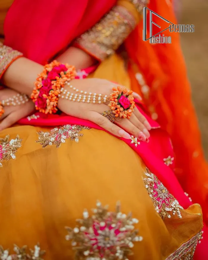 We seek outside the wonders we carry inside us. A mehndi dress in the mustard shirt is enhanced with gorgeous gota work. and is designed using the floral technique in pink and golden which is incrusted with tilla, dabka, kora and Sitara. The border of the mustard shirt is heavily ornamented with golden embroidery. The round neckline enhances the beauty of this mehndi dress when comes with three-quarter sleeves. It is paired up with mustard Gharara which is super simple and its border is encapsulated with Kiran. Complete this mehndi dress with a pink dupatta having ting floral motifs all over.