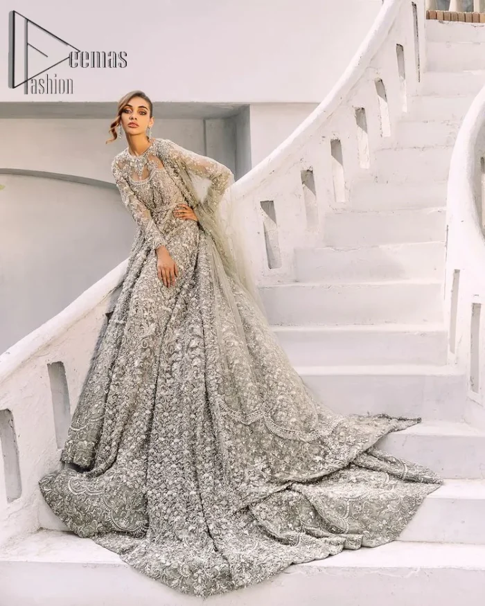 It was love at first swipe! Presenting this olive green back train maxi which is laboriously hand-rendered with silver and matching embroidery to make you a pure soulful bride. It is enhanced with tilla, dabka, kora and Kundan. The illusion neckline adds more beauty to this walima wear when comes with full sleeves. The back train flare is made just for you to catch more and more love from your loved ones. Complete this walima wear with a dupatta in the same colour which is handsomely embellished with a four-sided heavy border and sequins sprayed all over to receive more love.