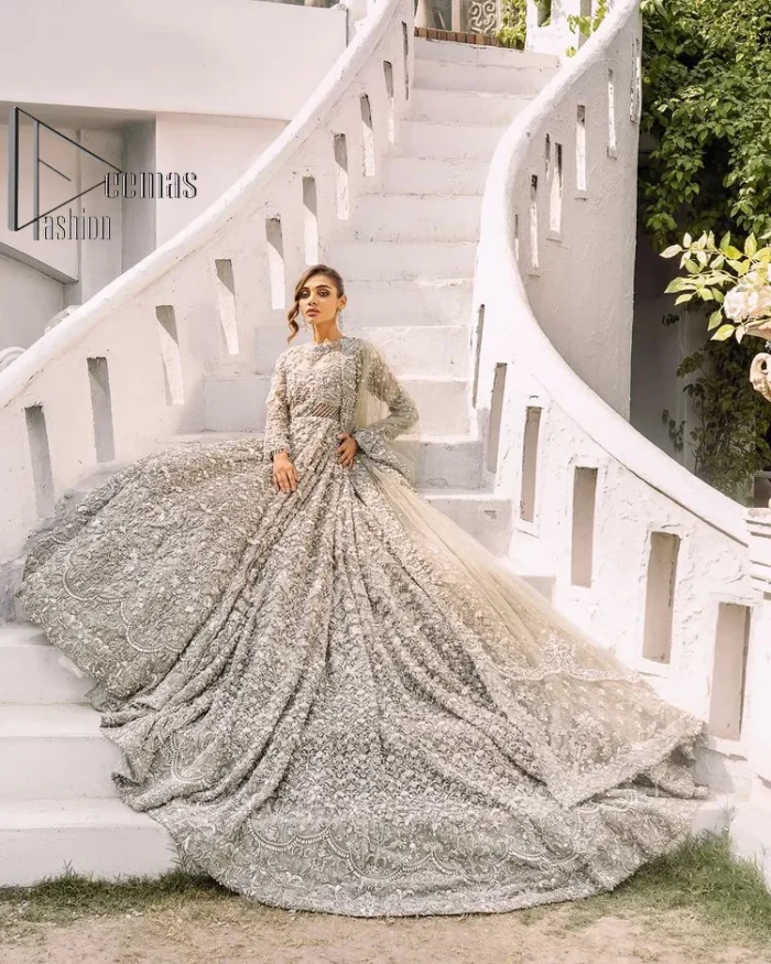 It was love at first swipe! Presenting this olive green back train maxi which is laboriously hand-rendered with silver and matching embroidery to make you a pure soulful bride. It is enhanced with tilla, dabka, kora and Kundan. The illusion neckline adds more beauty to this walima wear when comes with full sleeves. The back train flare is made just for you to catch more and more love from your loved ones. Complete this walima wear with a dupatta in the same colour which is handsomely embellished with a four-sided heavy border and sequins sprayed all over to receive more love.