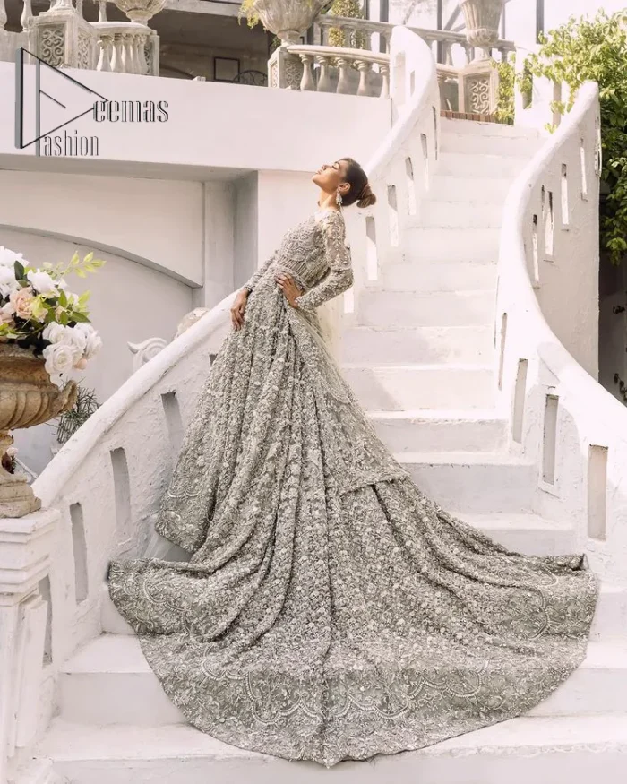 It was love at first swipe! Presenting this olive green back train maxi which is laboriously hand-rendered with silver and matching embroidery to make you a pure soulful bride. It is enhanced with tilla, dabka, kora and Kundan. The illusion neckline adds more beauty to this walima wear when comes with full sleeves. The back train flare is made just for you to catch more and more love from your loved ones. Complete this walima wear with a dupatta in the same colour which is handsomely embellished with a four-sided heavy border and sequins sprayed all over to receive more love.