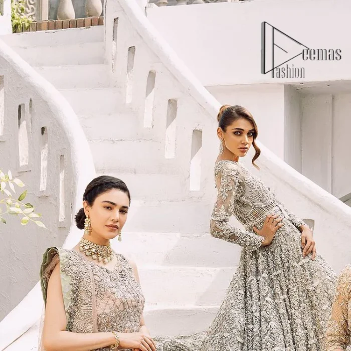 It was love at first swipe! Presenting this olive green back train maxi which is laboriously hand-rendered with silver and matching embroidery to make you a pure soulful bride. It is enhanced with tilla, dabka, kora and Kundan. The illusion neckline adds more beauty to this walima wear when comes with full sleeves. The back train flare is made just for you to catch more and more love from your loved ones. Complete this walima wear with a dupatta in the same colour which is handsomely embellished with a four-sided heavy border and sequins sprayed all over to receive more love.