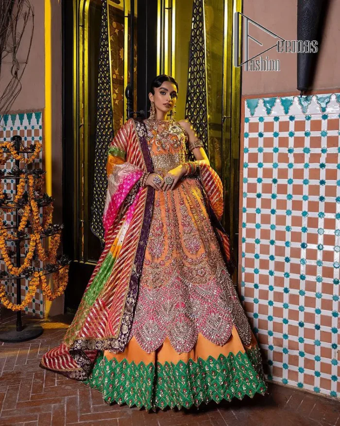 In a world full of trends, sometimes a bride just wants to wear something classic and traditional. In this way, DeemasFashion presents the major Pakistani walima dress which is nearest to the traditional style. The Pakistani walima dress starts from the orange pishwas which is beautifully styled with an illusion neckline and sleeveless. Further, it is enhanced with colourful embroidery which includes kora, dabka, tilla and Sitara to make your day super special. Pakistani walima dress is systemized with lehenga in the same colour but has a heavy green border to add beauty to the dress. Complete this Pakistani walima dress with a colourful dupatta to meet the following traditional trend.