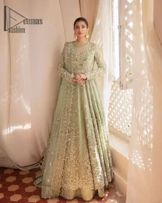 A time of life that is not just an occasion but a celebration. A pastel green scalloped maxi laboriously frosted with meticulously detailed hand embellished with silver tilla, dabka, and kora work blooming all over. Further, the jewel neckline and full sleeves of this article give so soothing feeling to you your walima day. It is handsomely coordinated with a pastel green lehenga that is again beautifully embellished. Complete this article with the organza dupatta in the same colour, heavily laden with a four-sided border and tiny floral motifs all over with a magical stream of pearls. 