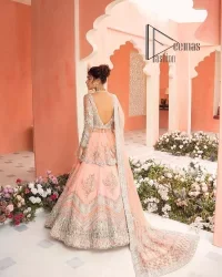 Feeling just peachy. DeemasFashion presents this peachy nikah outfit which begins with peplum in the peach colour. The following peplum is meticulously embellished with a silver embroidery which involves tilla, dabka, kora and Sitara. Further, the V shape neckline of the peplum looks as amazing as the embellished full sleeves. The Nikah outfit is coordinated with a fluffy lehenga having embellished borders and large floral motifs to make your day super peachy. Complete this nikah outfit with a dupatta which is adorned with four-sided embellished borders and floral motifs in the pattern.