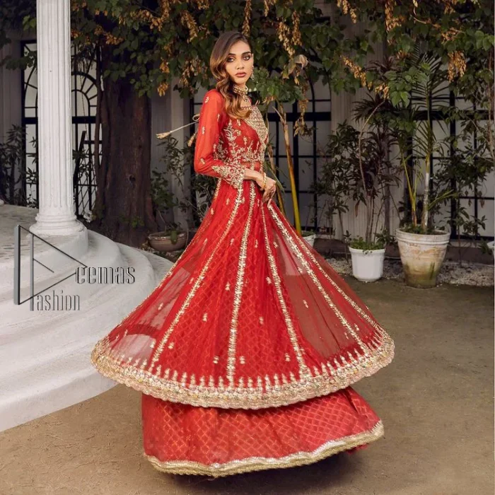 There is a shade of red in every mehndi wear. So, DeemasFashion presents this mehndi wear in the red shade which is handsomely ornamented with light golden embroidery and enhanced with tilla, dabka, kora and Zardozi. The square neckline adds more beauty to the outfit when comes with three-quarter sleeves. It is exquisitely combined with a red lehenga to make your mehndi more remarkable. Finish this mehndi wear with a dupatta in the rust colour which border is embellished with a four-sided Kiran and sequins spray all over to put amazing shade on your Mehndi.