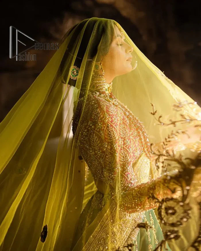 The blushing moment you found your dream mehndi outfit. This mehndi outfit is handsomely and attractively prepared in the level of contrast. Starting this mehndi outfit with a red blouse which is laboriously hand-rendered with light golden embroidery having tilla, kora, dabka and zardozi. In addition to this, it is enhanced with full sleeves and boat shape neckline to make your day super blush. The mehndi outfit is coordinated with a bottle green lehenga which is heavily ornamented with golden embroidery. Complete this article with a golden dupatta having Kiran on all sides. 