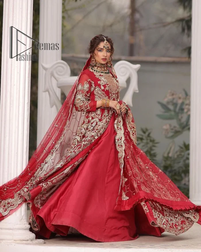 Marry someone who makes your heart shine. Wear what makes your soul shine. Introducing this Pakistani reception outfit which begins with a red blouse which is laboriously hand-rendered with silver embroidery to make your day super bright as silver colour. Further, it is highlighted with tilla, dabka, kora and crystal. The blouse of this Pakistani reception outfit is enhanced with boat shape neckline and three-quarter sleeves. The following blouse of the Pakistani reception outfit is systemized with a panelled lehenga in the same colour which is again heavily embellished. Complete this outfit with a frilled dupatta which is embellished with two-sided borders and sequins sprayed all over to make you shine.