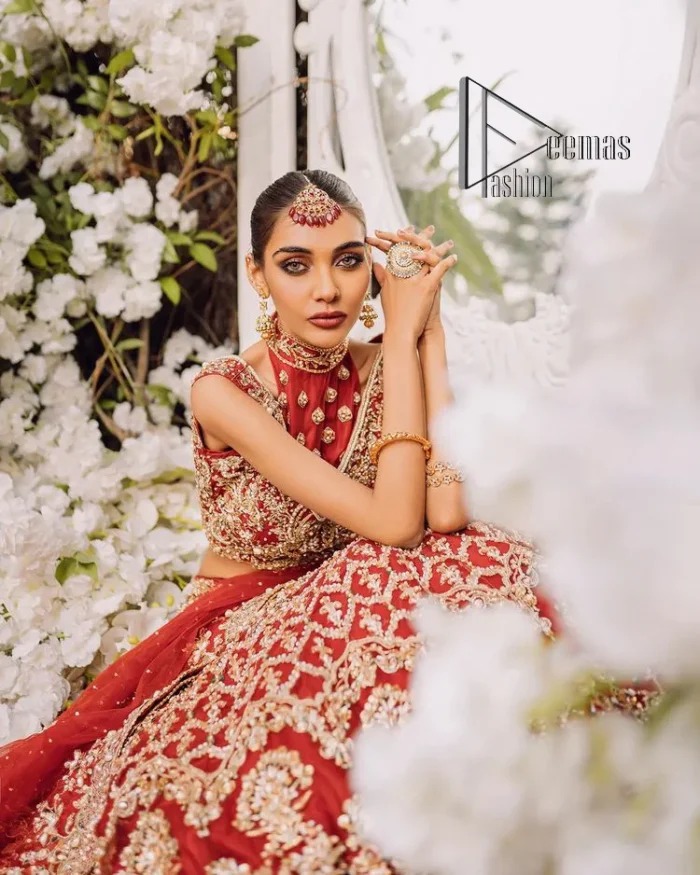 Every wedding comes with a bundle of emotion and love for the outfits. So, for this way DeemasFashion introduces this red reception wear which begins with a halter neck blouse which is exquisitely embellished with light golden embroidery which includes tilla, dabka, kora and zardozi. Further, the lehenga of this reception outfit is also adorned with heavy embroidery to boost your big day with love and emotions. Complete this reception wear with a dupatta in the same colour which is adorned with four-sided embellished borders and sequins sprayed all over.