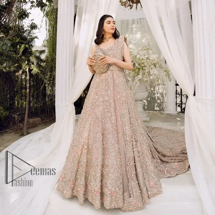 Boost your day with all about rose pink! Presenting the rose pink walima wear which begins with a heavy maxi that is beautifully hand-rendered with silver embroidery. It is attractively highlighted with tilla, dabka, kora and zardozi. The astonishing sleeveless style of the maxi looks super amazing when comes with a sweetheart neckline to make your day booster day. Furthermore, the back train of the maxi is also heavily ornamented. The walima wear is exquisitely paired up with a dupatta in the same colour which is embellished with four-sided borders and sequins sprayed all over.