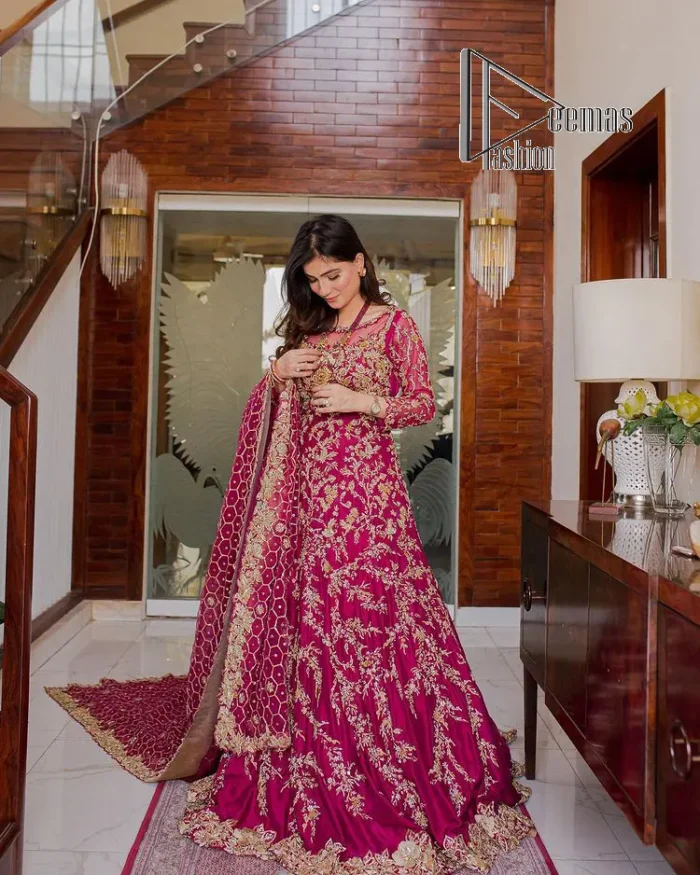 Stripes are the new pinky vibes. Introducing the Pakistani walima dress in the shade of shocking pink. This easy-breezy, romantic silhouette, is laboriously frosted with meticulously detailed golden embroidery which includes tilla, dabka, kora and Kundan. The handsome illusion neckline gives an extra soothing view to this Pakistani walima dress when comes with three-quarter sleeves. The heavily hand-rendered maxi is paired up with a dupatta in the same colour which is again embellished with four-sided borders and sequins sprayed all over to make your day super fresh.