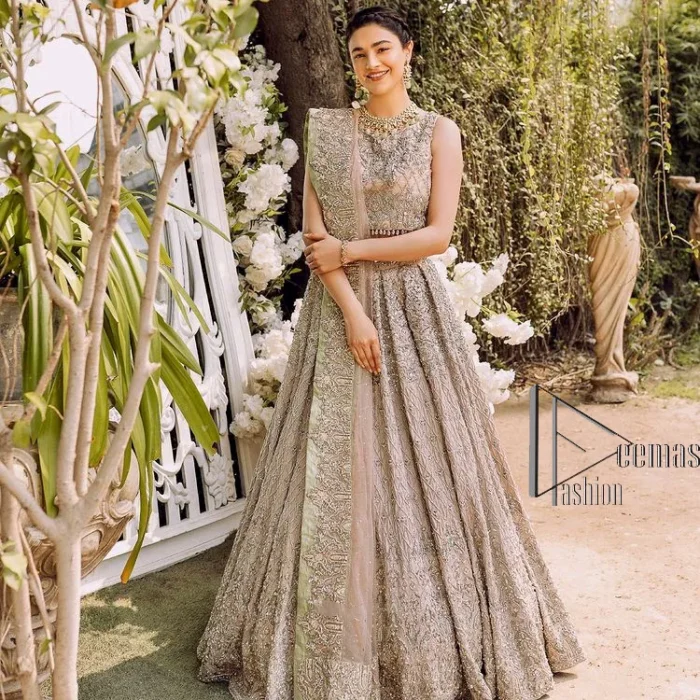 Go with tea rose on your Big day. DeemasFashion presents tea rose nikah wear to fulfil your dreamy look. The blouse in the tea rose colour is heavily ornamented with silver embroidery that enhances with tilla, dabka, kora and zardozi. Further, It is detailed with a round neckline and finished with a sleeveless style. The nikah wear is paired up with can-can lehenga which is heavily embellished to make you the spotlight among all. Complete this article with a dupatta which is enhanced with four-sided embellished borders and sequins sprayed all over to make your day more memorable and attractive.
