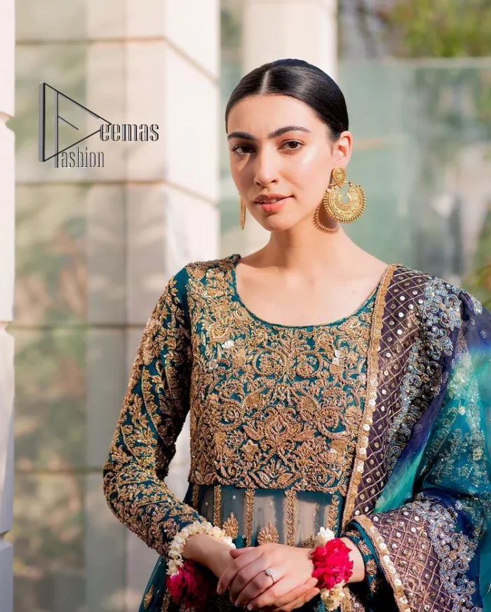 The bride wears blue just touches the blues of the sky. DeemasFashion introduces this teal blue mehndi outfit which begins with panelled Anarkali. The following Anarkali is exquisitely hand-rendered with a light golden embroidery which involves tilla, dabka, kora and zardozi. The floral motifs are also embellished on panels to make this Anarkali priceless. Furthermore, the round shape neckline and full sleeves also enhance the beauty of this mehndi outfit. It is handsomely and attractively paired up with brocade lehenga which gives a unique pieace of charmless.