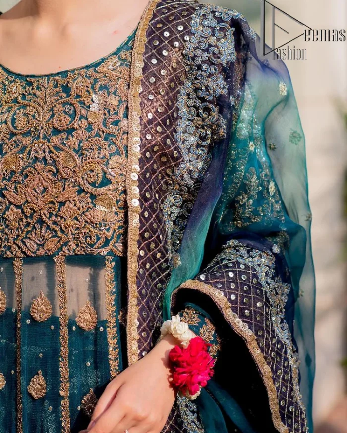 The bride wears blue just touches the blues of the sky. DeemasFashion introduces this teal blue mehndi outfit which begins with panelled Anarkali. The following Anarkali is exquisitely hand-rendered with a light golden embroidery which involves tilla, dabka, kora and zardozi. The floral motifs are also embellished on panels to make this Anarkali priceless. Furthermore, the round shape neckline and full sleeves also enhance the beauty of this mehndi outfit. It is handsomely and attractively paired up with brocade lehenga which gives a unique pieace of charmless.