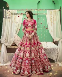 A wine that will make you rise and shine n your Big day. Begin this reception wear with wine red blouse which is beautifully adorned with golden embroidery and further enhance with tilla, dabka, kora and Sitara. The round shape neckline of the blouse meticulously comes with full sleeves. The reception wear also includes the flared lehenga in the same colour which is highlighted with multiple colour embroidery as well. In parallel to this, the dupatta in the same colour is heavily adorned with four-sided borders and floral motifs all over to make you rise and shine in this reception wear.