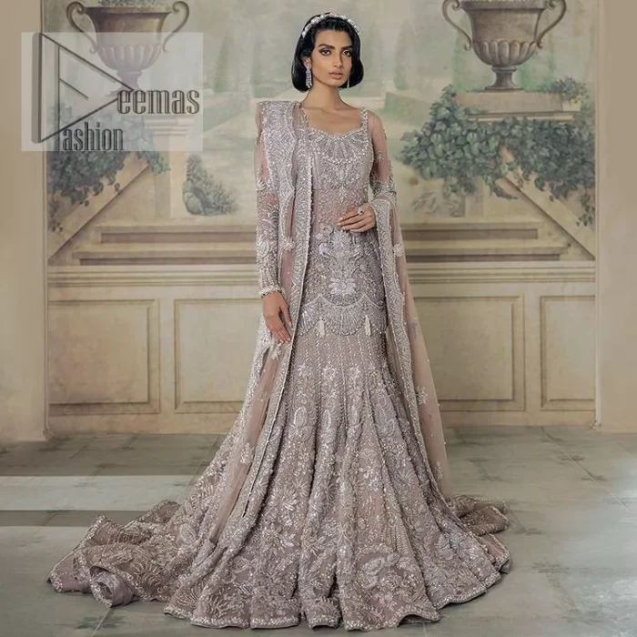 Luxurious canvas embodying grace and style! It is a well-crafted short shirt enhanced with silver embroidery accentuated with gleaming ornaments. The following shirt is incrusted with tilla, dabka, kora, zardozi and beautiful detailing of crystal. Further, it is coordinated with a back train lehenga which is meticulously adorned with heavy embroidery to make you the real dreamy fairy. Complete this Walima article with a dupatta in the same colour, framed with a four-sided border. The tiny floral motifs and sequins sprayed spread all over on the dupatta for memorable grace.
